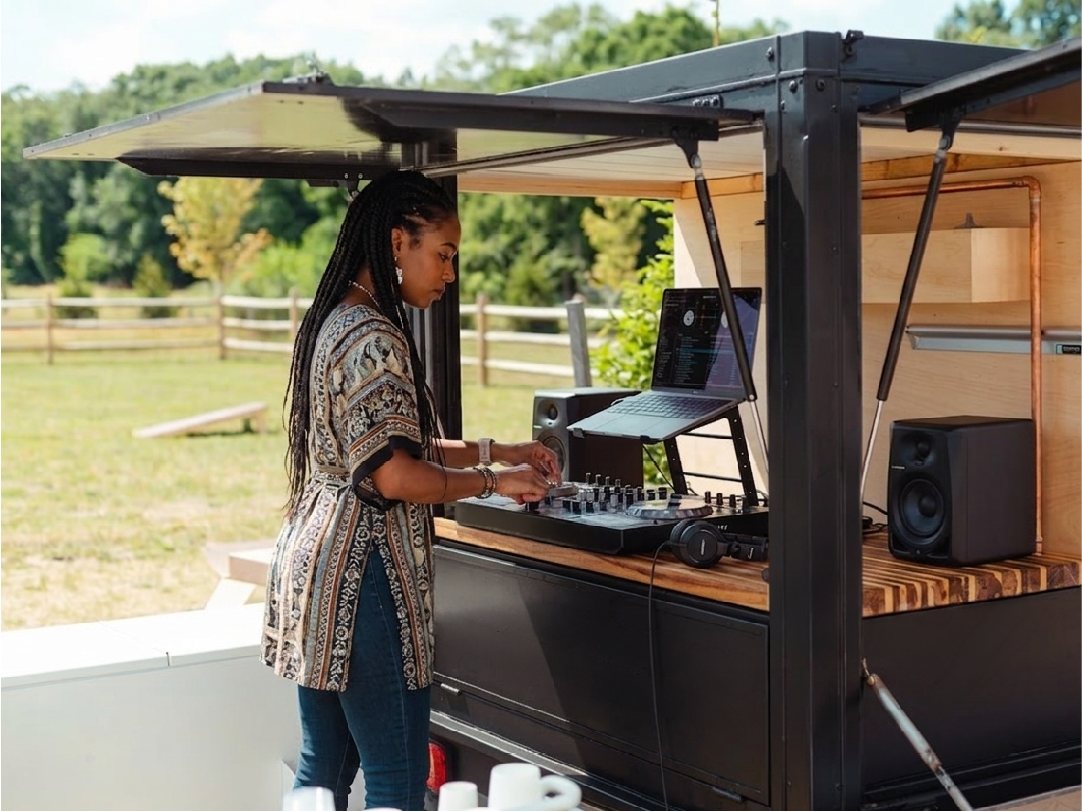 A DJ playing from the booth built into the back of the van